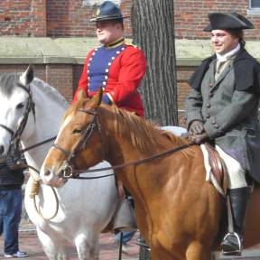 Outrider Darin Reale (left) and his brother Richard (right) dressed as Paul Revere, pose for pictures in Revere Park.