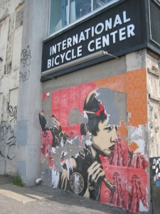 Unfinished work by controversial graffiti artist Shepard Fairey covers the side of the International Bicycle Center on Brighton Avenue.